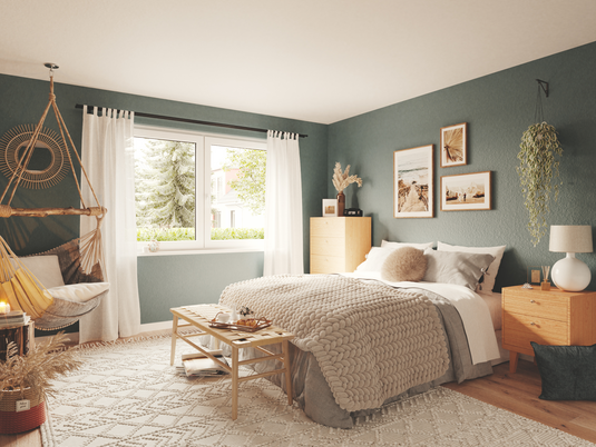 Schlafzimmer im Massivhaus Bungalow 128 Gemütliches Schlafzimmer im Bungalow 128 mit großen Fenstern und warmen Farben. Ausdruck von Wohnkomfort im Massivhaus.