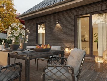 Terrasse mit Klinkerfassade an einem Massivhaus. Beispiel für zeitlose und langlebige Architektur.